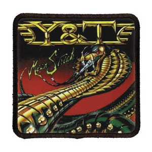 May include: A black and gold patch with the band name "Y&T" and the album title "Mean Streak" in white lettering. The patch features a green and gold snake with a red background.