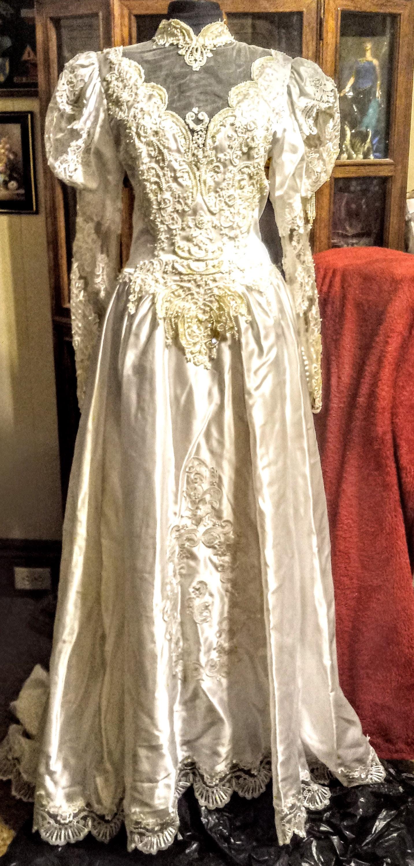 Very lacy size 4-6 traditional white wedding dress long sleeves beautiful  train buttons back with invisible zipper and a high neck.