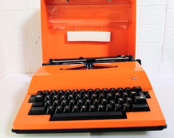 Máquina de escrever portátil vintage/Máquina de escrever moderna laranja que não funciona/Máquina de escrever elétrica antiga Adler Triumph Gabriella/Máquina de escrever retrô/Anos 70