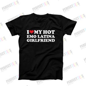 May include: Black t-shirt with white text and a red heart. The text reads "I MY HOT EMO LATINA GIRLFRIEND". The shirt is a crew neck style.