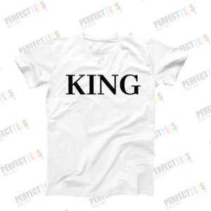 May include: White t-shirt with the word "KING" printed in black on the front.