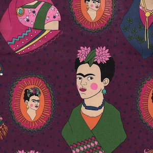 May include: A dark purple fabric featuring a repeating pattern of Frida Kahlo portraits. Some portraits are framed in pink and green oval medallions, while others show the figure wearing a green shawl with a pink and green diamond pattern.