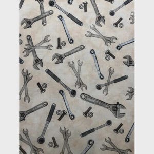 Tool Toss Cotton Fabric: Streets of Fire Cream. By Quilting Treasures