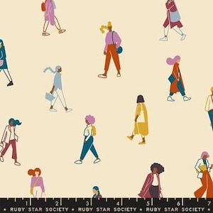 May include: Cream-coloured fabric featuring a repeating pattern of stylized figures in various poses. The figures are outlined in black and filled with colours like pink, blue, orange, and yellow. The fabric has a ruler graphic along the bottom with the text "RUBY STAR SOCIETY".