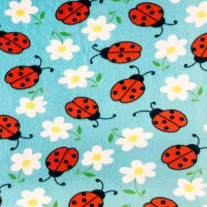 Fleece stof met all-over print lieveheersbeestjes - 60" breed - op maat verkocht