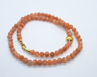 sunstone necklace with 18k gold bead and 14k gold clasp