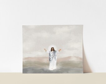 May include: A square print featuring a watercolor illustration of a figure in white robes with arms outstretched. The figure is surrounded by a soft, glowing light, set against a backdrop of muted earth tones and a cloudy sky.