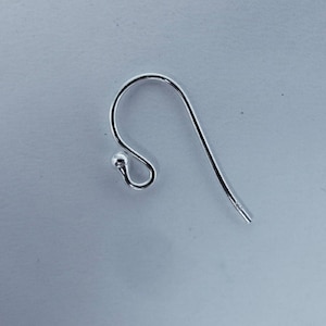 May include: Silver earring hook with a small ball at the top.