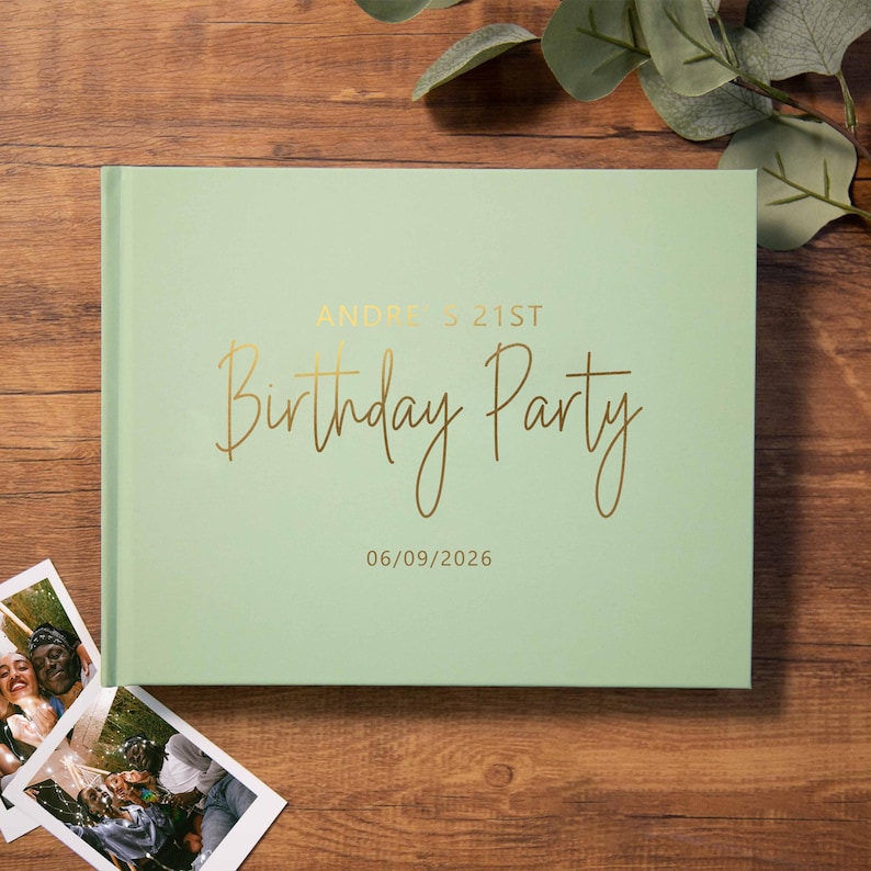 May include: A light green rectangular photo album with gold foil text that reads Andre's 21st Birthday Party and the date 06/09/2026. The cover features a smooth matte finish and is positioned next to two small square photographs.