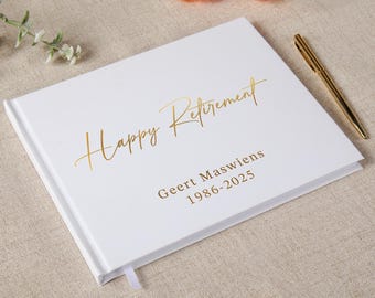May include: A white rectangular guest book with gold foil lettering that reads Happy Retirement, Geert Maswiens, 1986-2025. The book is accompanied by a gold metallic pen, and the cover features a clean, smooth finish with a small white ribbon bookmark.