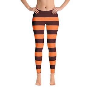 May include: Orange and brown striped leggings. The leggings are a fitted style and have a wide waistband.