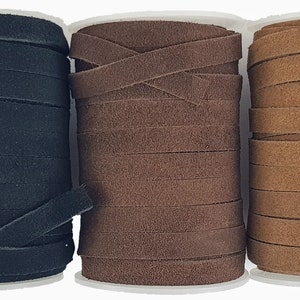May include: Three spools of leather cord in black, brown, and tan. The cord is approximately 6 mm wide and is wound tightly on the spools.