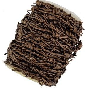 May include: A roll of brown barbed wire, a type of fencing material, is coiled up on a white spool.