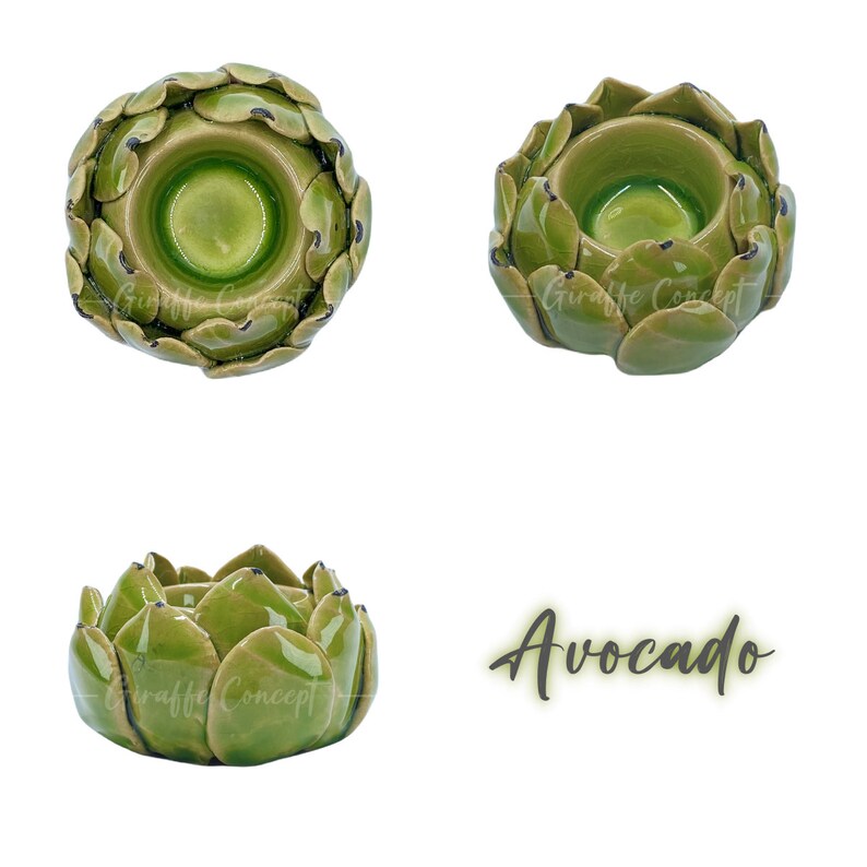 May include: Three ceramic artichoke-shaped candle holders in shades of green with a glossy finish. The word "Avocado" is written in a script font. The candle holders are designed to hold candles.
