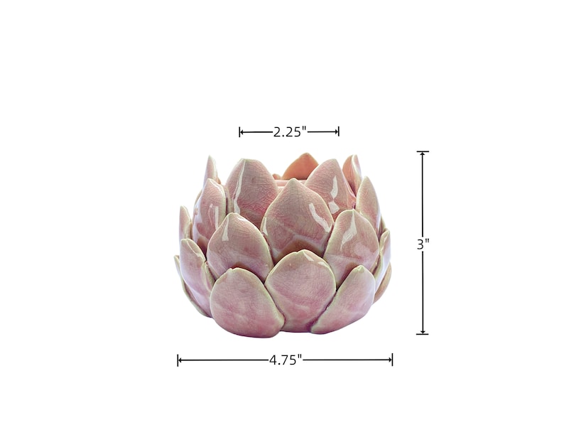 May include: A pink ceramic planter shaped like a flower with 4.75 inches in diameter and 3 inches in height.