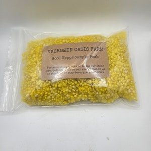 May include: A small clear plastic bag filled with yellow wool nepps. The bag has a label that reads "EVERGEEN OASIS FARM Wool Nepps Sample Pack". For more sample packs or to see our other products and info on our events follow us on facebook or etsy @evergreenoasisfarm