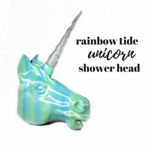 May include: A rainbow striped unicorn shower head with a silver glitter horn. The text "rainbow tide unicorn shower head" is written below the unicorn.