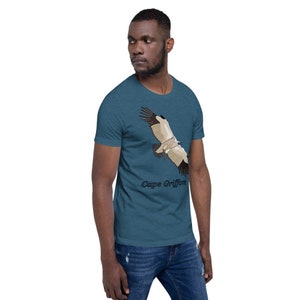 May include: A teal blue t-shirt featuring a graphic of a Cape Griffon in flight. The text "Cape Griffon" is printed below the bird.