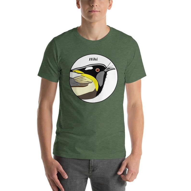 May include: A green t-shirt featuring a white circle with a colourful illustration of a bird, labelled "Hihi" above it.