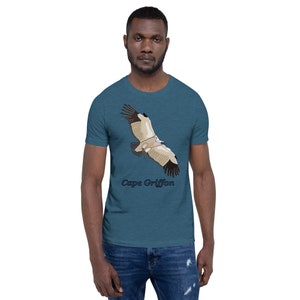 May include: A teal blue t-shirt featuring a graphic of a Cape Griffon in flight. The text "Cape Griffon" is printed below the bird.
