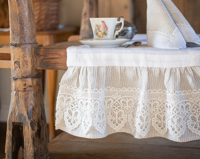 Romantic white linen table runner with ruffle and wide lace.