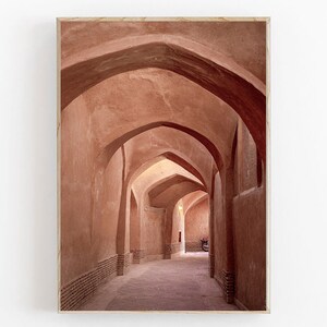 May include: A long, narrow hallway with arched ceilings made of red-brown brick. The hallway is lit by natural light coming in from the top of the arches.