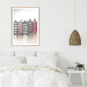 May include: A framed photograph of a row of colorful houses reflected in a canal. The houses are a mix of red, black, and white. The sky is a light blue with a few clouds.