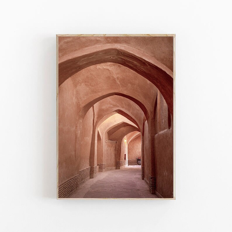 May include: A long, narrow hallway with arched ceilings made of red-brown brick. The hallway is lit by natural light coming in from the top of the arches.