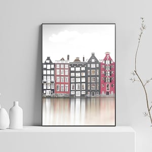 May include: A black and white photograph of a row of colorful houses reflected in a canal. The houses are a mix of red, black, and white.