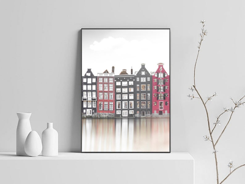 May include: A black and white photograph of a row of colorful houses reflected in a canal. The houses are a mix of red, black, and white.