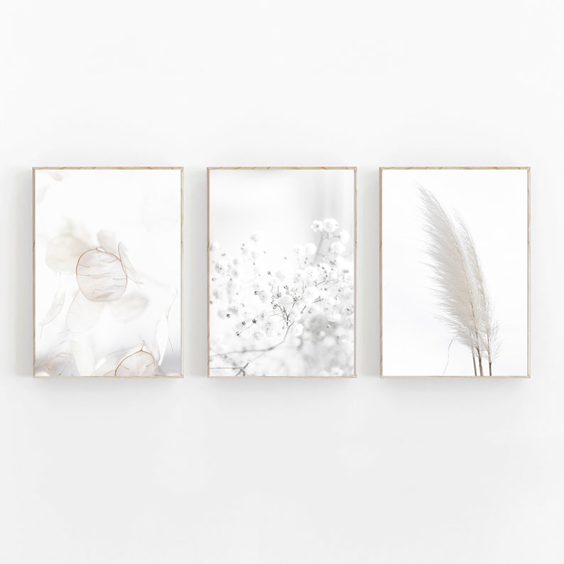 May include: Set of three minimalist art prints featuring abstract floral and feather designs in shades of white and gray.