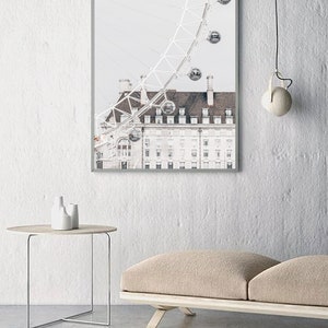 May include: A framed photograph of a white building with a large Ferris wheel in the background. The Ferris wheel is partially visible and has several gondolas. The building has a tiled roof and many windows.