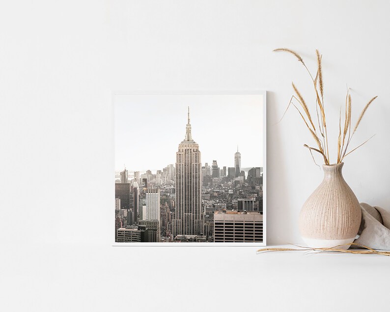 May include: A black and white photograph of the New York City skyline with the Empire State Building in the center.