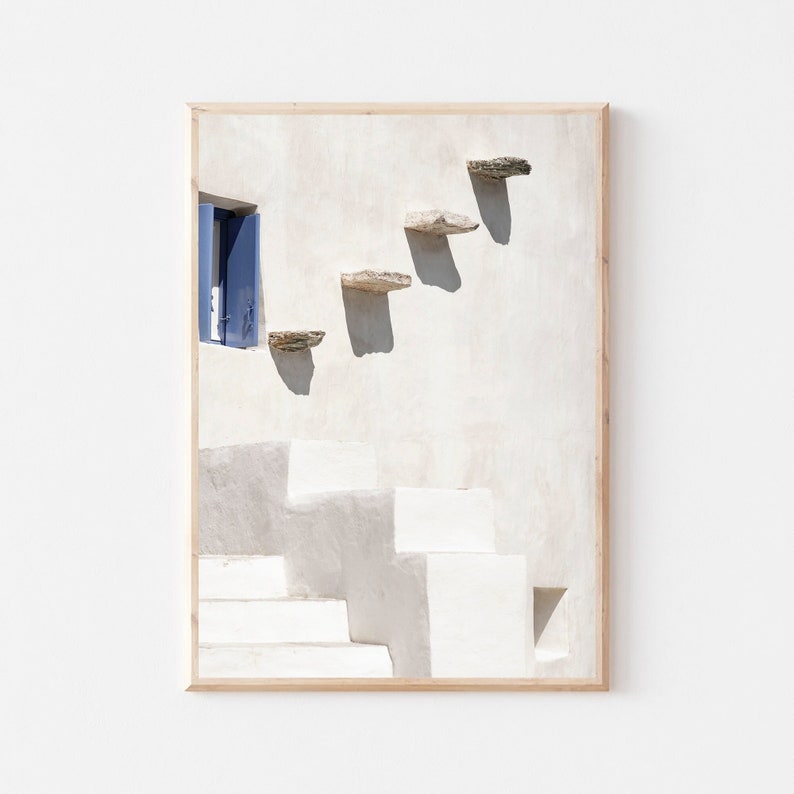 May include: A white building with a blue door and a set of stone steps leading up to it. The steps are made of flat, rectangular stones.