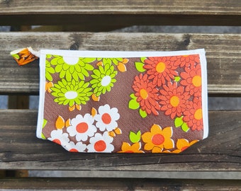 Black vintage toiletry kit with red, orange, green, white flowers