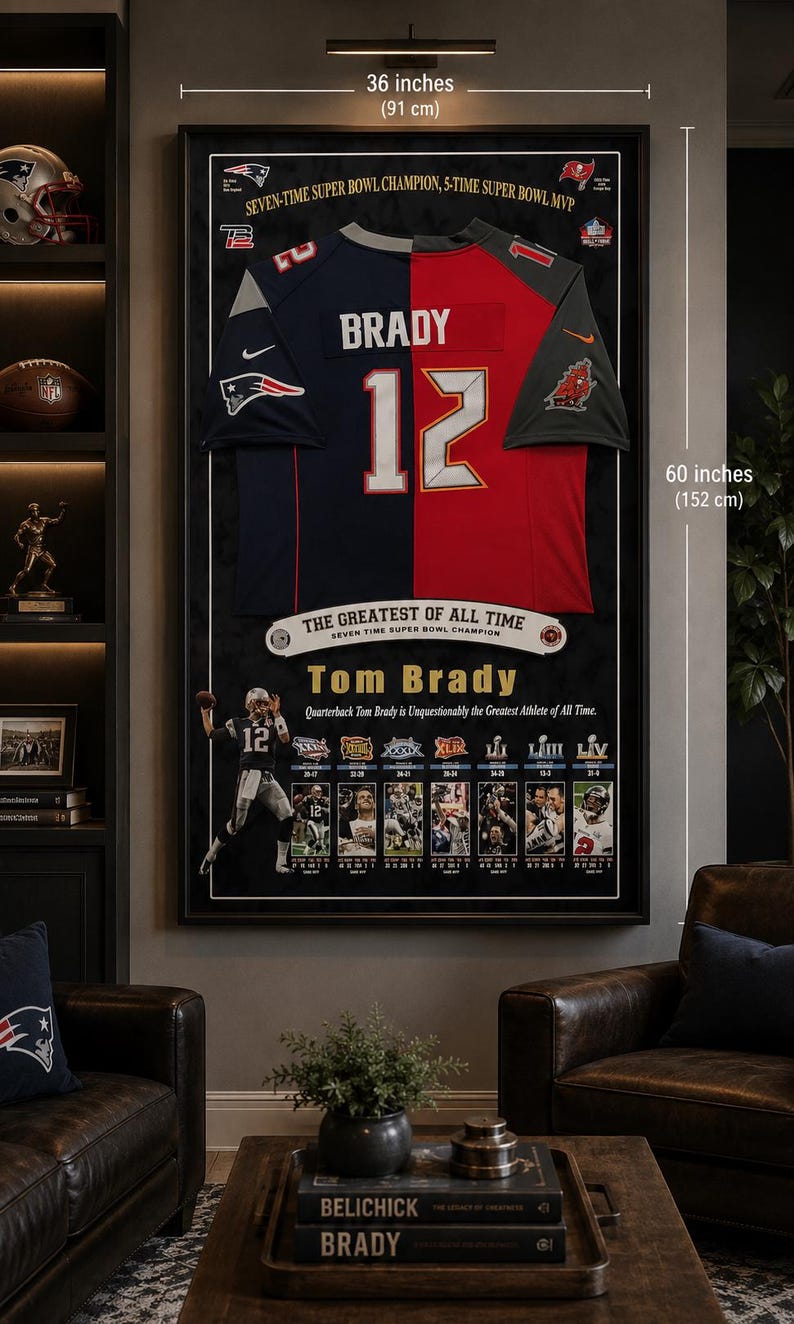 May include: Framed Tom Brady jersey, 36 x 60 inches, featuring his name and number 12. The jersey is split into navy blue and red sections. The frame includes text: "THE GREATEST OF ALL TIME" and images of Brady.
