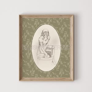 May include: A black and white illustration of a person doing laundry in a washtub with a washboard. The illustration is framed in a light wood frame with a green floral pattern.
