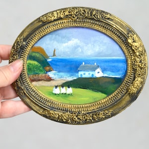 Cuadro ovalado de paisaje irlandés con ovejas en marco vintage.