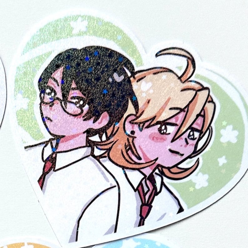 May include: A sticker featuring a cartoon illustration of two people with short hair. The person on the left is wearing glasses and a red tie. The person on the right is wearing a red tie and has a blush on their cheeks. The background is green with white flowers.