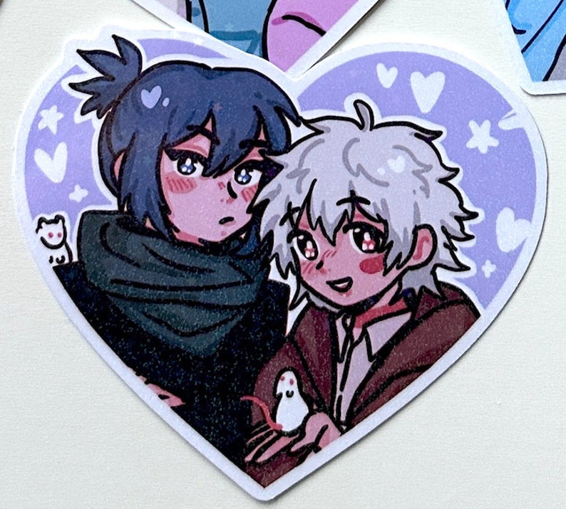 May include: A heart-shaped sticker with two anime characters, one with blue hair and a green scarf, and the other with white hair, holding a small white mouse. The background is a light purple with white hearts and stars.