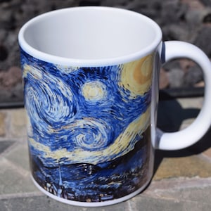 May include: White ceramic mug with a colorful image of Vincent van Gogh's "Starry Night" painting.
