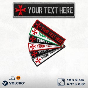 May include: Set of six embroidered iron-on or sew-on patches featuring a red Maltese cross and the text "YOUR TEXT HERE". The patches are available in black, white, red, green, and grey. The patches measure 12 cm by 2 cm.
