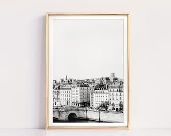 May include: Black and white framed print of a cityscape featuring buildings, a bridge, and a river. The print has a gold frame and the text "OH FINE! ART PRINTS | DIGITAL DOWNLOAD" at the bottom.