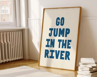 May include: A framed poster with a white background and a blue text overlay that reads "GO JUMP IN THE RIVER".