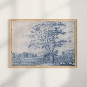 May include: A framed print showing a blue and white landscape. The image features a large tree as the focal point, with a field and trees in the background. The print is presented in a wooden frame.