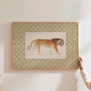 May include: A framed print of a tiger walking on a white background. The frame has a green and yellow geometric pattern.