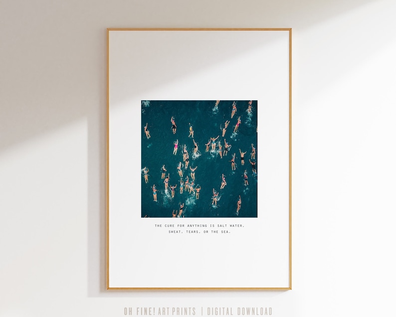 May include: A teal blue ocean with many people swimming. The text "THE CURE FOR ANYTHING IS SALT WATER, SWEAT, TEARS, OR THE SEA." is printed below the image.