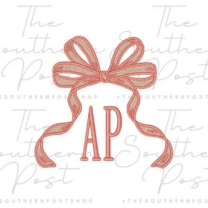 May include: Embroidered design featuring a bow with flowing ribbons and the letters "AP" in a serif font. The bow is a coral color with a tan trim. The text "The Southern Post Shop" is in the background.