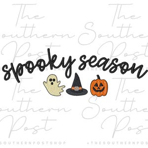 May include: An embroidery design featuring the black text "spooky season" in a cursive font. Below the text are three embroidered icons: a beige ghost, a black witch hat with an orange band, and an orange jack-o'-lantern with a black face.