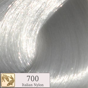 May include: A close-up of a silver hair color product with the number 700 and the text "Italian Nylon" printed on the label.